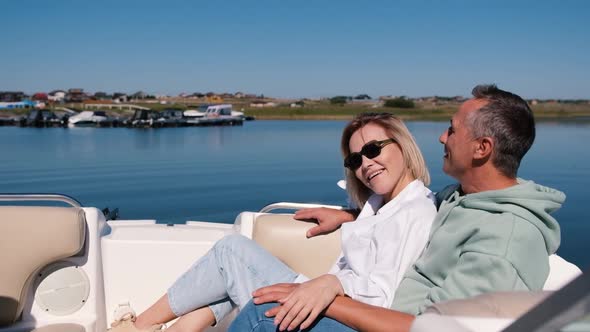 Young Woman and Man Ride a Speedboat