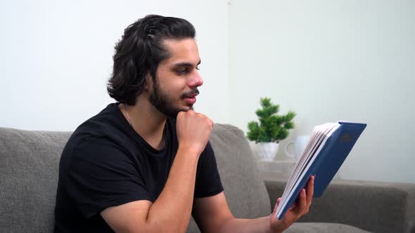 Delightful Indian man reading a book