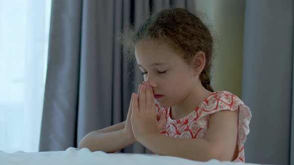 Little Girl is Praying in Her Room