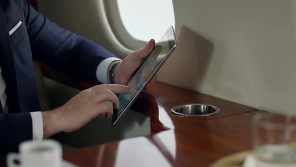 Closeup Passenger Holding Tablet in Hands