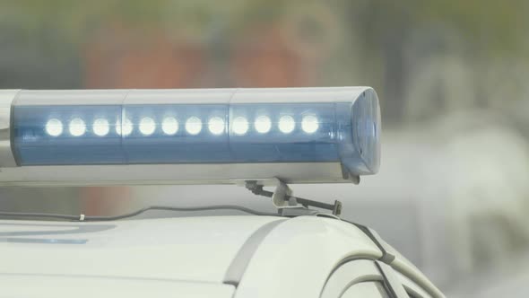 Flashing Flasher on the Roof of a Police Car. Blinker. Close-up.