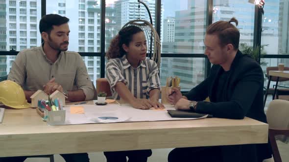 Creative Business People Group Having Conversation at Office Desk in Workplace