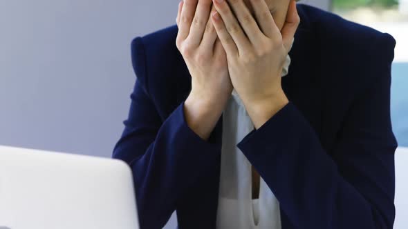 Businesswoman crying at desk 