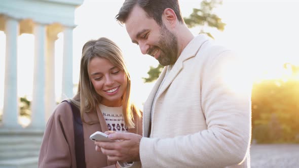 Smiling couple looking at the phone