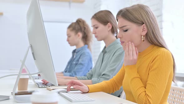 Attractive Young Female Designer Having Toothache in Office