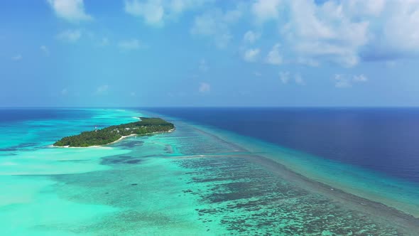 Beautiful above clean view of a white sandy paradise beach and blue ocean background in vibrant 4K