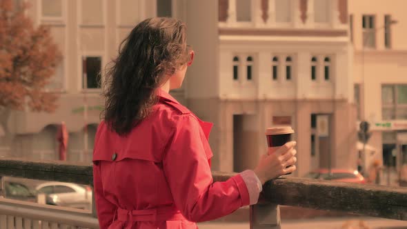 Attractive Woman Drinking Coffee on Bridge