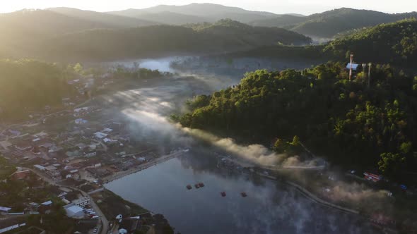 Aerial View of Sunrise with Fog Over Ban Rak Thai Chinese Village Near a Lake in Mae Hong Son