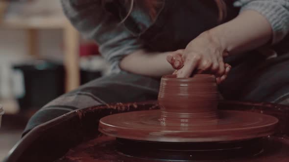 Closeup Shot of a Master Female Potter Molding Wet Clay Into a Bowl on Spinning Potter's Wheel