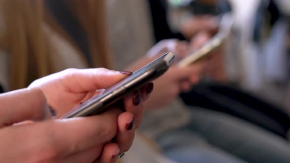 Group of People Use Mobile Phones in a Cafe Instead of Communicating with Each Other