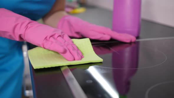 Hands of Housekeeper Washing Kitchen Stove