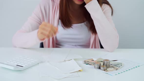 Stressed young woman calculating monthly home expenses