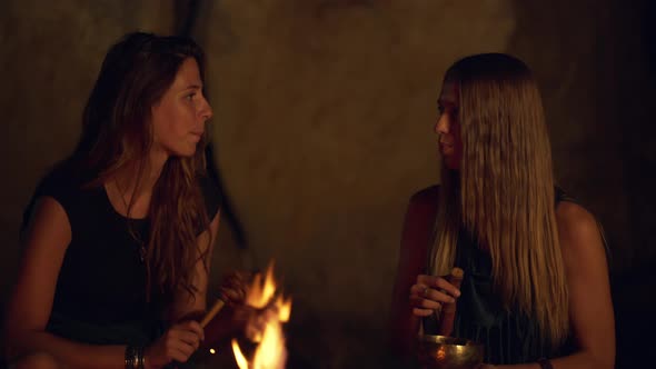 Friends Speaking Smiling Playing on Instruments Sitting Near Bonfire at Night Beach