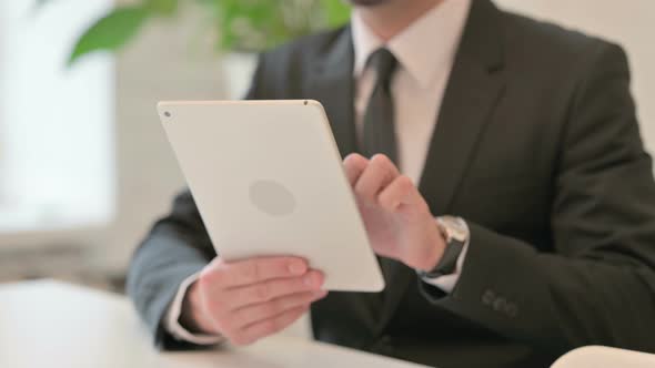 Close Up of Hands of Middle Aged Businessman Celebrating Success on Tablet