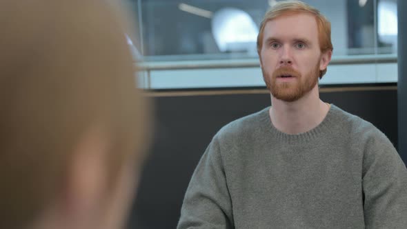 Rear View of Young Man Having Conversation with Woman