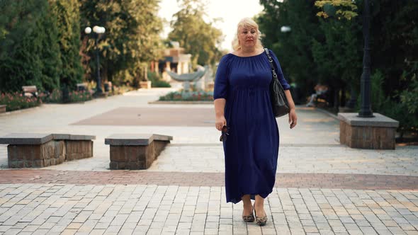 Overweight Woman Walking the City Street