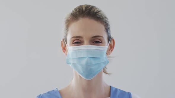 Female health worker wearing face mask at home