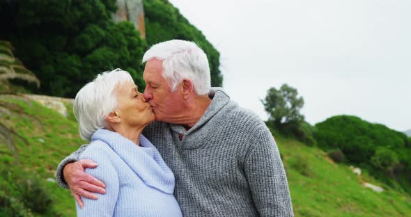 Senior man kissing senior woman