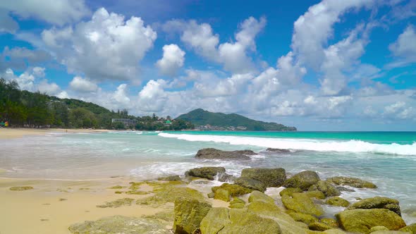 Seascape in sunny day white clouds beautiful blue sky rock and sand beach Phuket Thailand