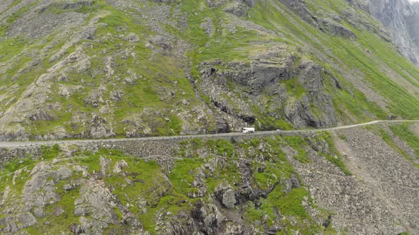 View Of Vehicles Traveling Across Cliff Edge Road Of Trollstigen In Norway. - Aerial Tracking Shot