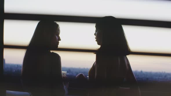 Two girls talking and connecting on the balcony