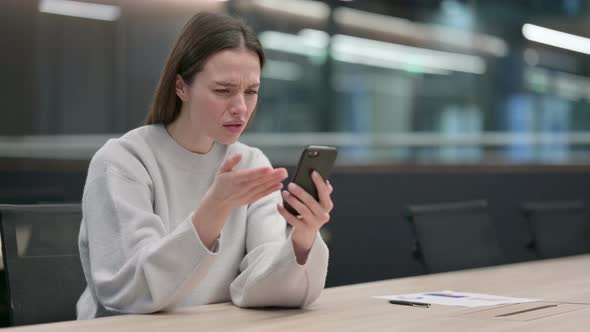 Upset Woman Reacting to Loss on Smartphone