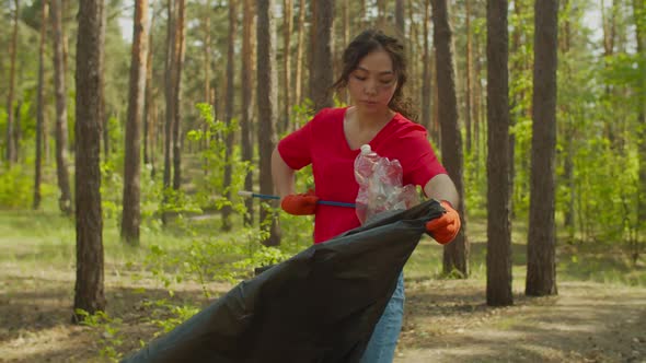 Asian Woman Eco Activist Collecting Trash Outdoors