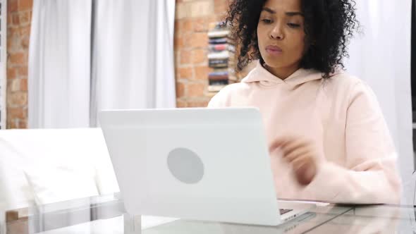 Young AfroAmerican Woman Listening Music and Dancing at Home