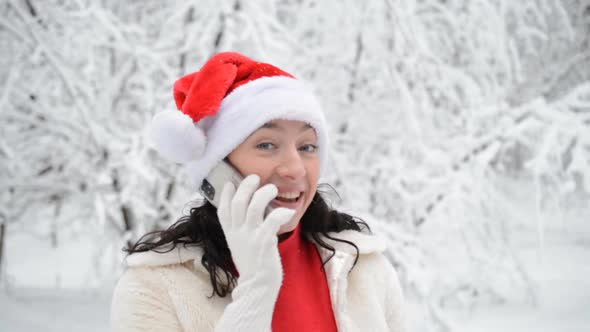 Beautiful Girl Portrait in Santa Claus Clothes in Winter Forest