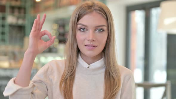 Portrait of Ok Sign By Cheerful Young Woman 