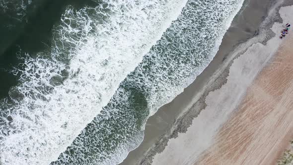 Drone Flying Over Ocean Waves Crashing on the Beach