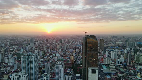 Brilliant Sunset Over Phnom Penh Skyline With View Of Golden Tower - aerial