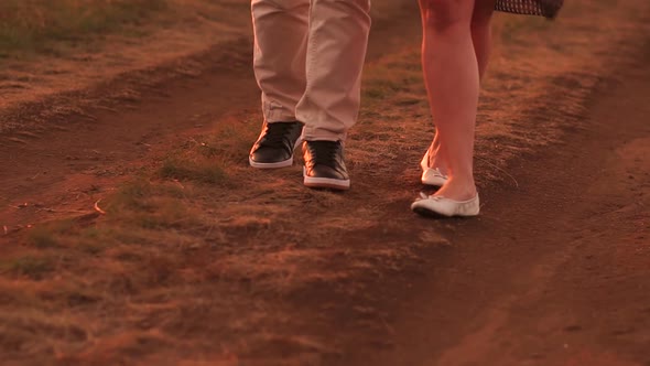 Closeup of Couple in Love Walking Along a Country Road in the Summer at Sunset