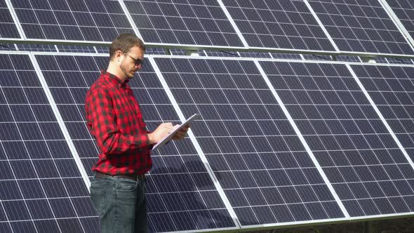 Successful Young Engineer Planning Futuristic Solar Panels Power Plant
