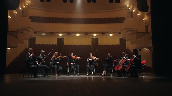 Orchestra on Scene of Opera House Four Violins Two Cellos Bassoon and Flute Musicians Playing