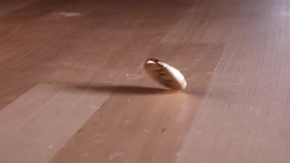 the coin is spinning on a wooden table