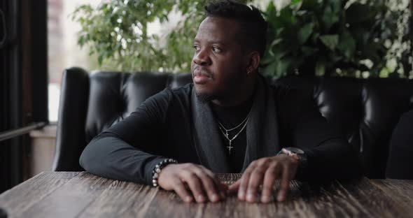 Confident African Man Sitting at the Table