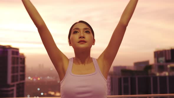 View of Young asian Woman Sitting on Mat and Practicing Yoga