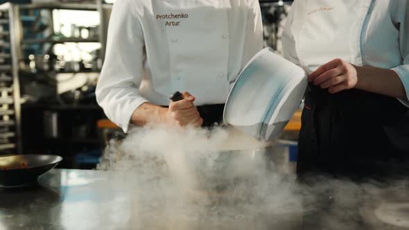 Professional kitchen: liquid nitrogen is added during the cooking of a molecular dish