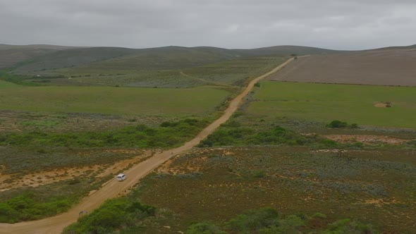 Aerial View of Car Driving on Dirt Road in Countryside