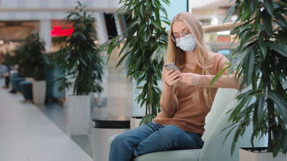 Caucasian Busy Woman in Medical Mask Sitting on Sofa Business Chatting