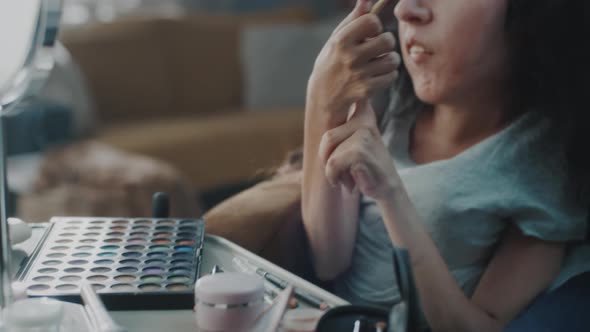 Woman in a Wheelchair Doing Eye Makeup