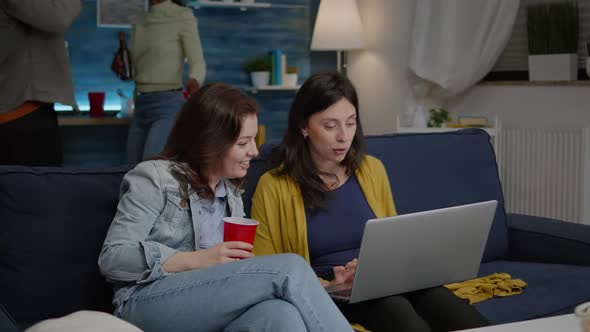 Multiethnic Women Enjoying Time Together Watching at Movie on Laptop