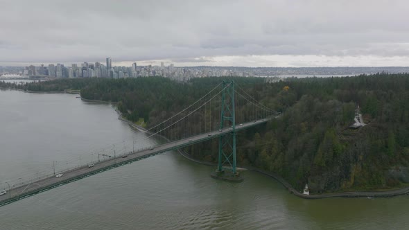 Aerial Shot flying towards Vancouver cityscape over the Lions Gate Bridge in 4K