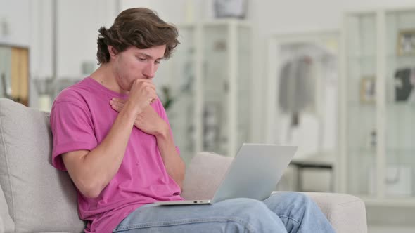 Sick Casual Young Man Using Laptop Coughing at Home 