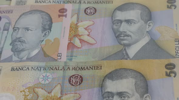 Paper banknotes of Romania in a row slow tilt 3840X2160p 30fps UltraHD  video -  Close-up of Romania