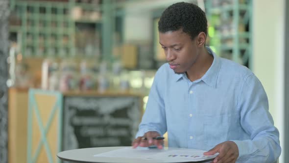 Professional Young African Man Reading Documents