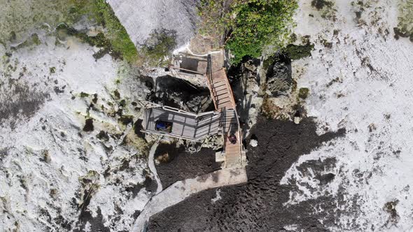 The Rock Restaurant in Ocean Built on Cliff at Low Tide on Zanzibar Aerial Top