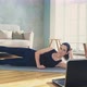 Woman Does Supine Side Leg Raises Watching Online Training - VideoHive Item for Sale