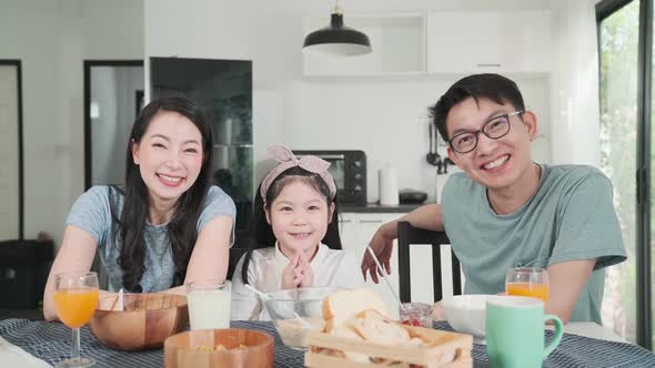 Happiness Asian Japanese family  breakfast at home. young parent and daughter